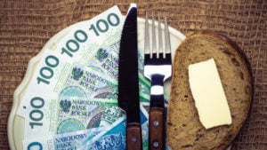 Polish money on kitchen table, coast of living